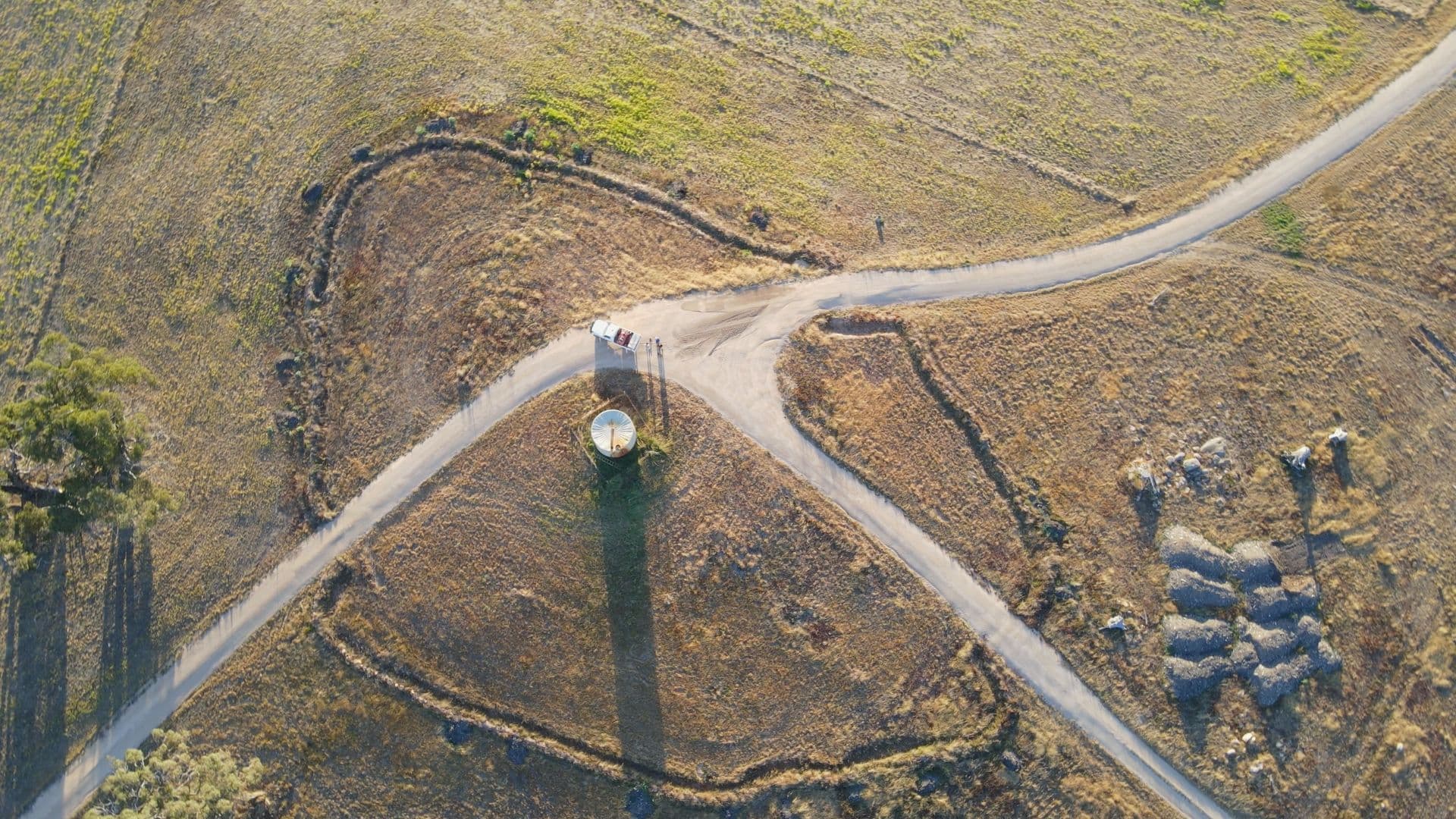 Aerial view of paddocks either side of a farm track